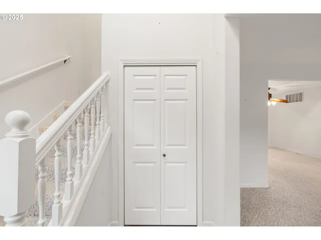 a view of an empty room with a fireplace and a window