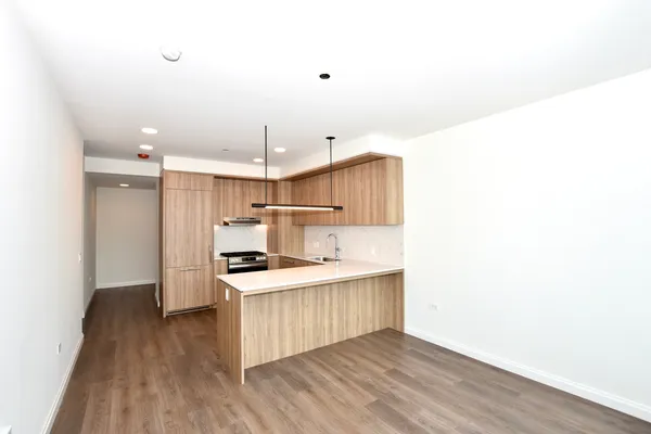 a kitchen with stainless steel appliances a stove top oven a sink and a refrigerator
