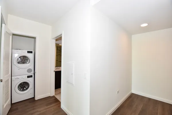 a view of washer and dryer with wooden floor