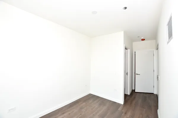 a view of a room with wooden floor