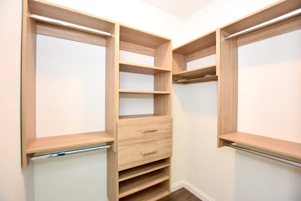 a view of walk in closet with empty racks