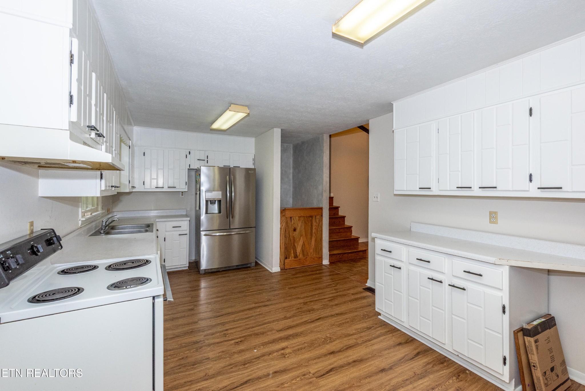 133 Windham Road Oak Ridge, TN 37830 - Photo 10 of 35 a kitchen with stainless steel appliances a stove a refrigerator and cabinets