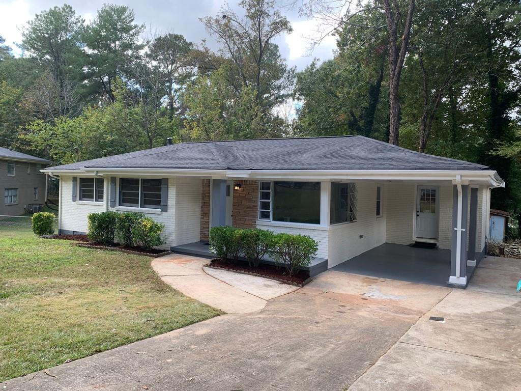 2225 Barbara Lane Decatur, GA 30032 - Photo 1 of 1 a front view of a house with a yard and potted plants