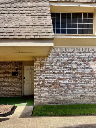 a view of a brick house with a large window