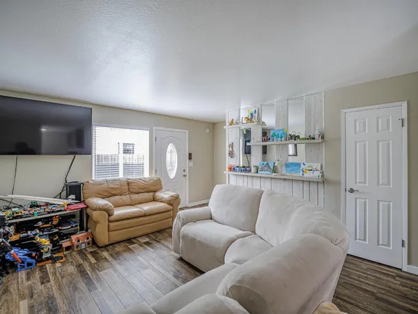a bedroom with a bed and painting on the wall