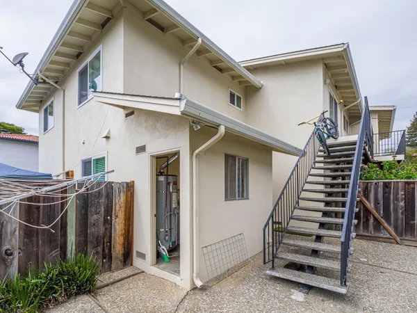 a kitchen with a refrigerator a stove a sink dishwasher and wooden cabinets with wooden floor