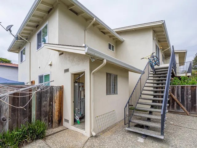 a kitchen with a refrigerator a stove a sink dishwasher and wooden cabinets with wooden floor