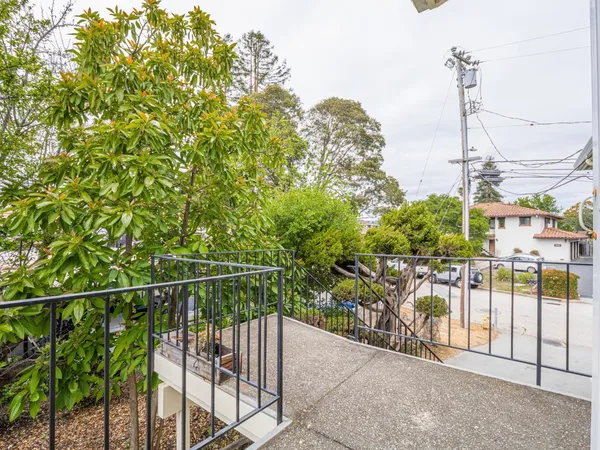 a kitchen with stainless steel appliances granite countertop a sink a stove a refrigerator a washer and dryer with wooden floors
