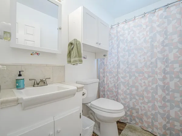 a bathroom with a toilet a sink and bathtub