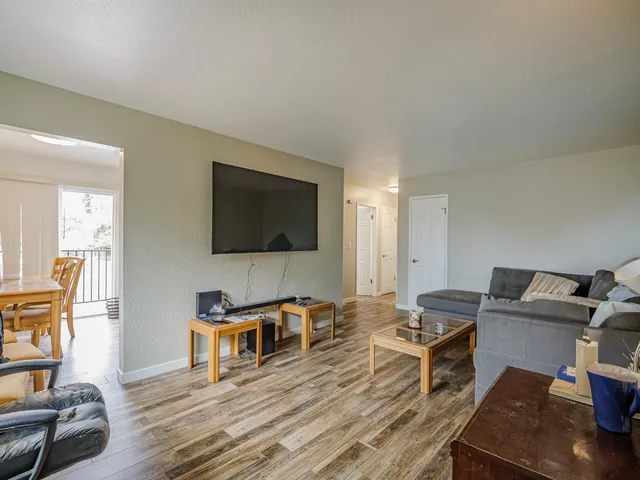 a kitchen with a table chairs refrigerator and cabinets