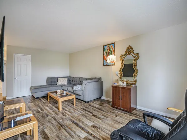 a bedroom with furniture and a wooden floor