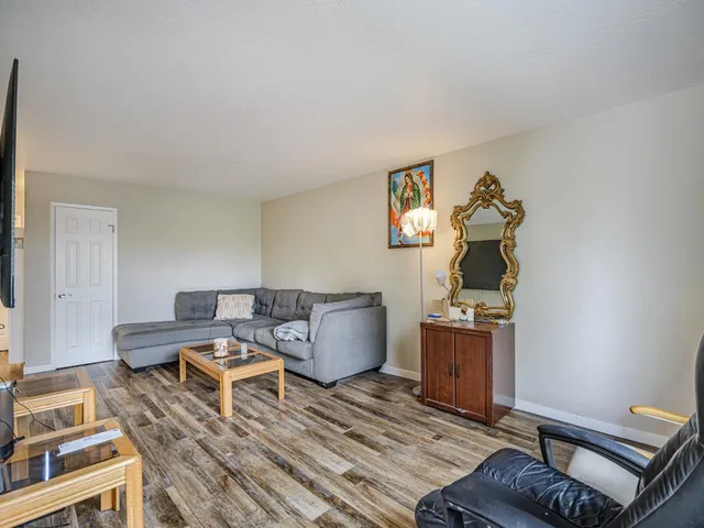 a bedroom with furniture and a wooden floor