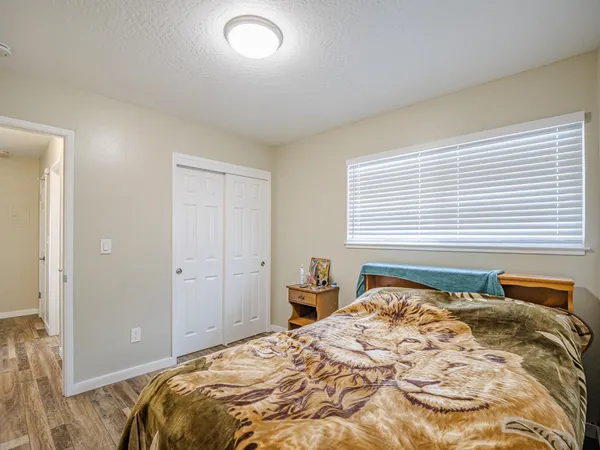 a bedroom with a bed and a flat screen tv