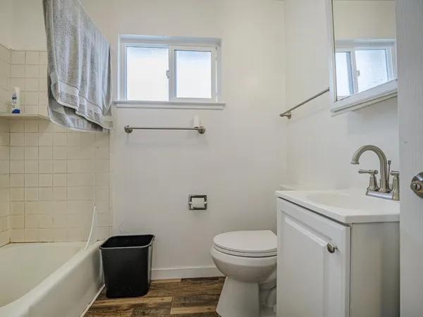 a view of a house with backyard and a tree