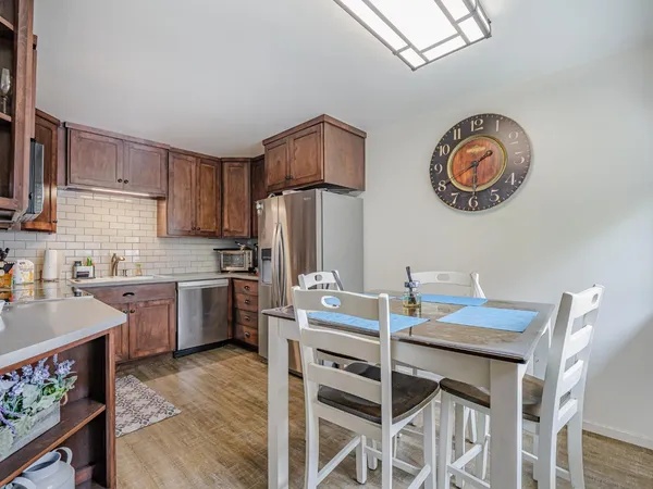 a view of a patio with table and chairs under an umbrella