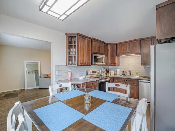 a backyard of a house with table and chairs plants
