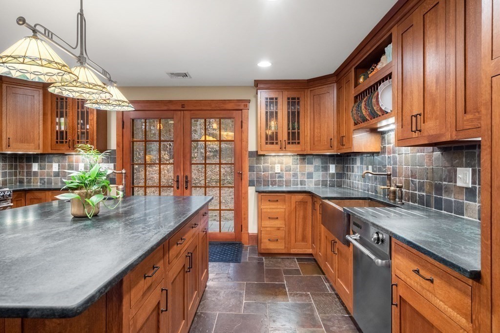 43 Boxford Road Ipswich, MA 01938 - Photo 8 of 37 a kitchen with stainless steel appliances granite countertop a sink a stove and a wooden cabinets