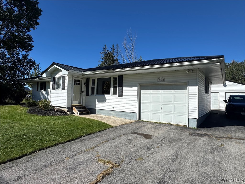 10180 Partridge Road Colden, NY 14080 - Photo 3 of 34 Classic siding and a dark metal roof highlight this charming ranch-style exterior.