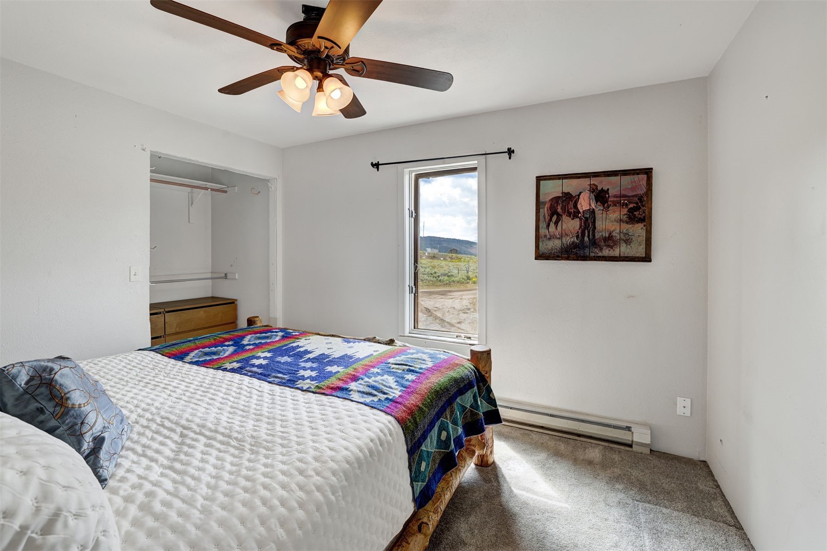 1703 Elk Run Road Silverthorne, CO 80498 - Photo 38 of 46 a bedroom with a bed and a painting on the wall