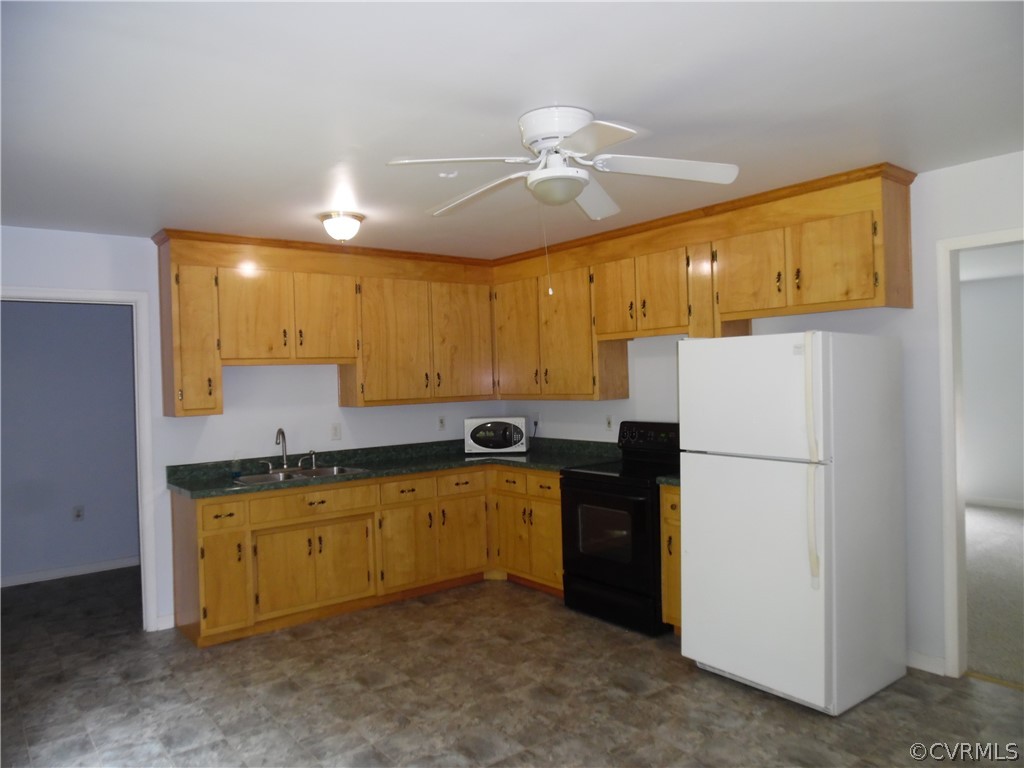 11500 Reedy Branch Road Chesterfield, VA 23838 - Photo 13 of 25 a kitchen with a refrigerator a stove top oven and cabinets