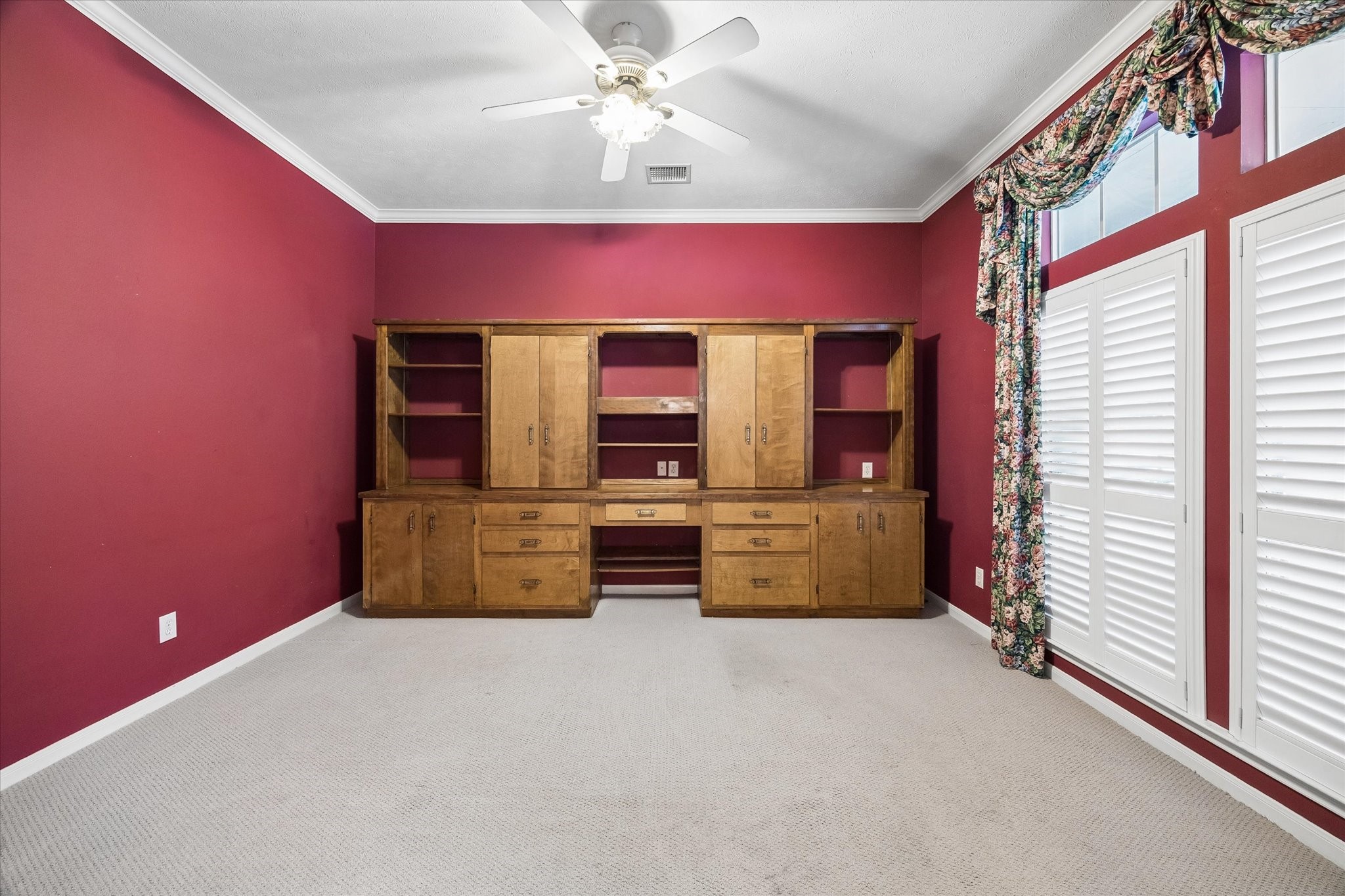 1203 Bingle Road Houston, TX 77055 - Photo 4 of 21 Charming study or formal living room, featuring a built-in wooden cabinet and desk.