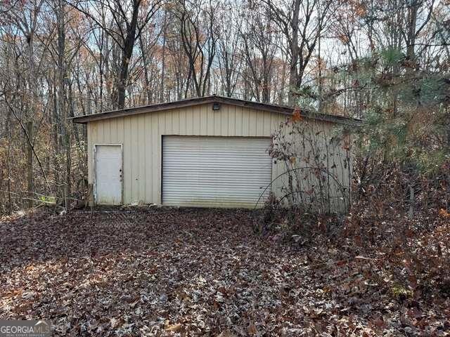 857 Laurel Lane Winder, GA 30680 - Photo 2 of 3 a backyard of a house with lots of plants and trees