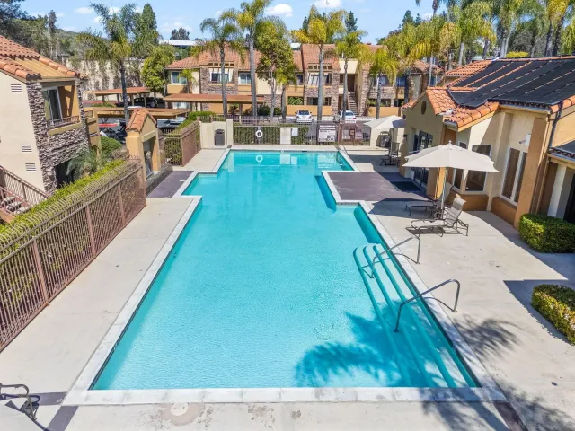 a view of a tennis ground with large trees