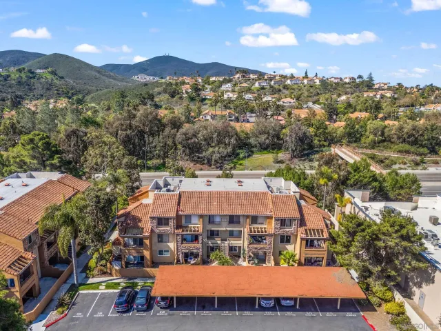 a view of a balcony with dining table & chairs