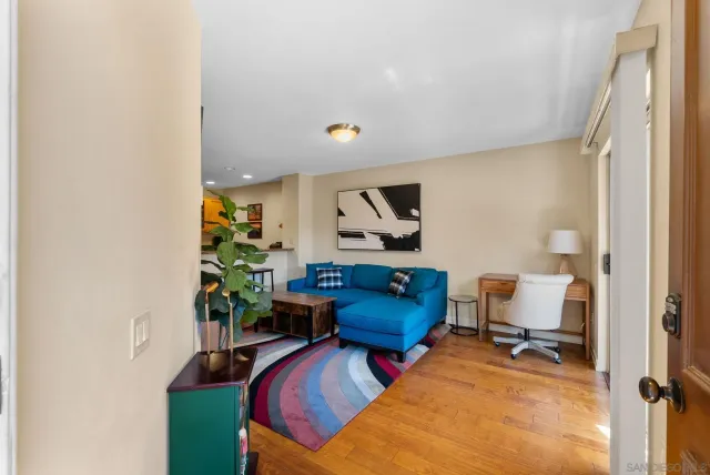 a living room with furniture and a potted plant
