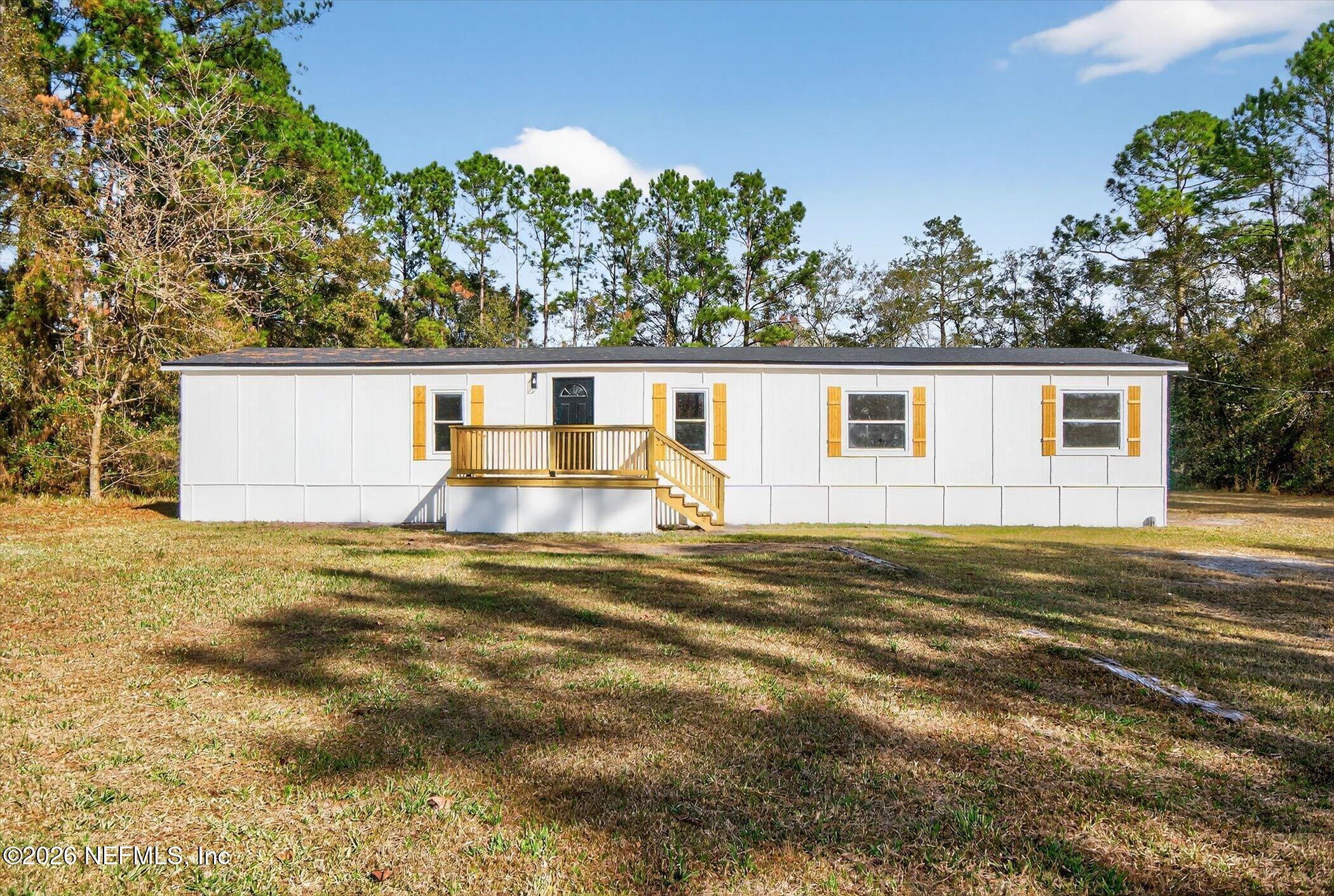 a view of a house with backyard and swimming pool