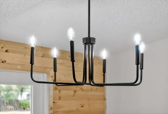 a view of an empty room with a fireplace and a window