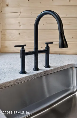 a kitchen with a wooden floor and window