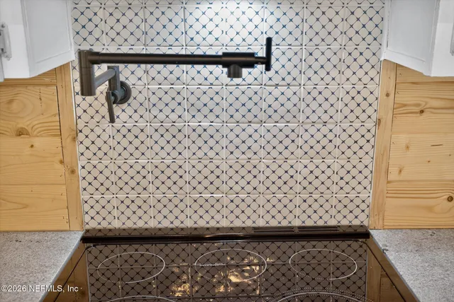 a kitchen with granite countertop a sink cabinets and stainless steel appliances