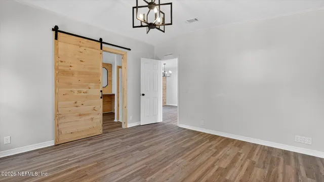 a view of an empty room and wooden floor