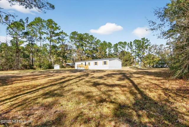 a view of yard with large trees