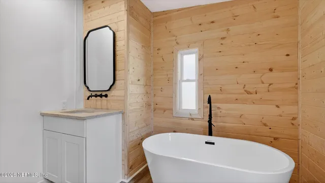 a view of a house with wooden fence