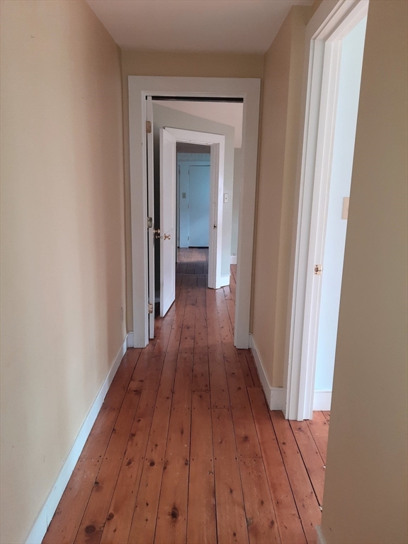 58 Main Street, Unit 2 Marshfield, MA 02050 - Photo 12 of 13 a view of a hallway with wooden floor