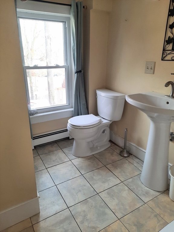 58 Main Street, Unit 2 Marshfield, MA 02050 - Photo 13 of 13 a bathroom with a toilet a sink and a window