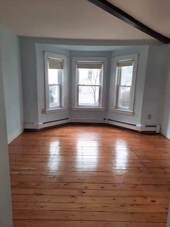 58 Main Street, Unit 2 Marshfield, MA 02050 - Photo 9 of 13 a view of empty room with wooden floor and fan
