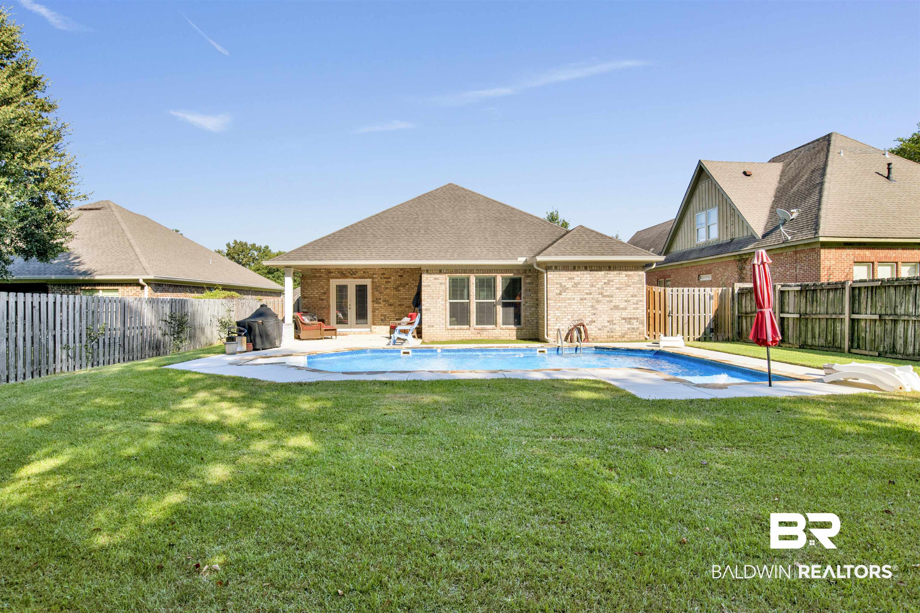 360 Scarlett Avenue Fairhope, AL 36532 - Photo 33 of 34 Rear view of house featuring a fenced in pool, a yard, and a patio