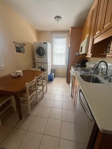 a kitchen with a sink a stove and a microwave
