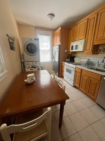 a kitchen with a sink a stove and chairs