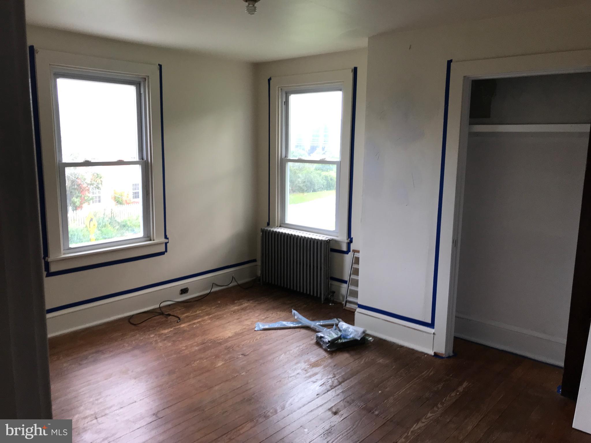 2033 Hopewell Road Oxford, PA 19363 - Photo 14 of 19 an empty room with wooden floor a ceiling fan and windows