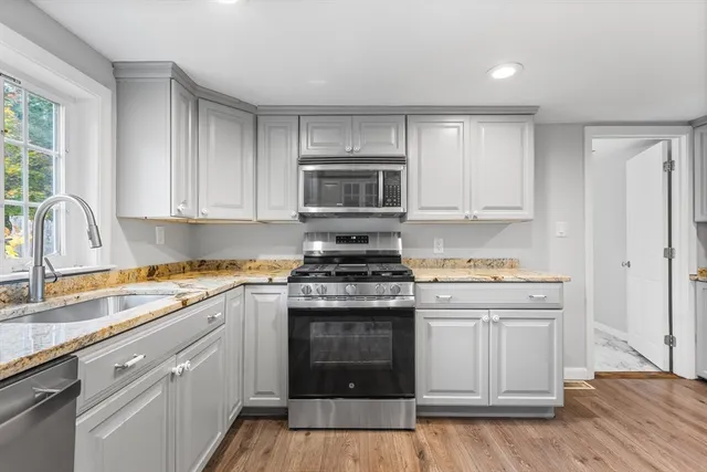 a kitchen with a stove oven and sink