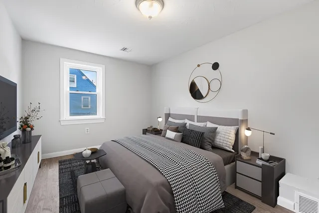 a bedroom with bed and a window