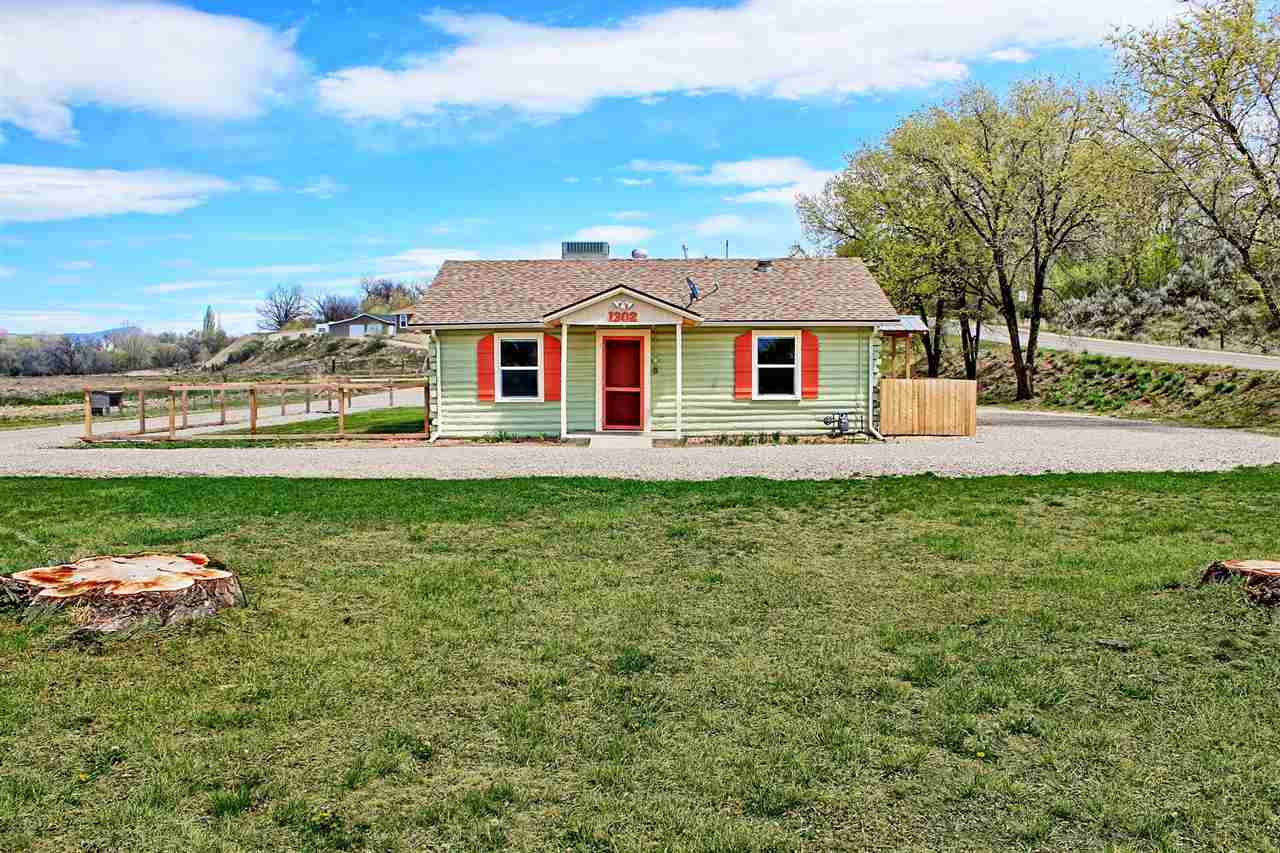 1302-17 17 1/2 Road Fruita, CO 81521 - Photo 1 of 39 a front view of a house with a garden and yard