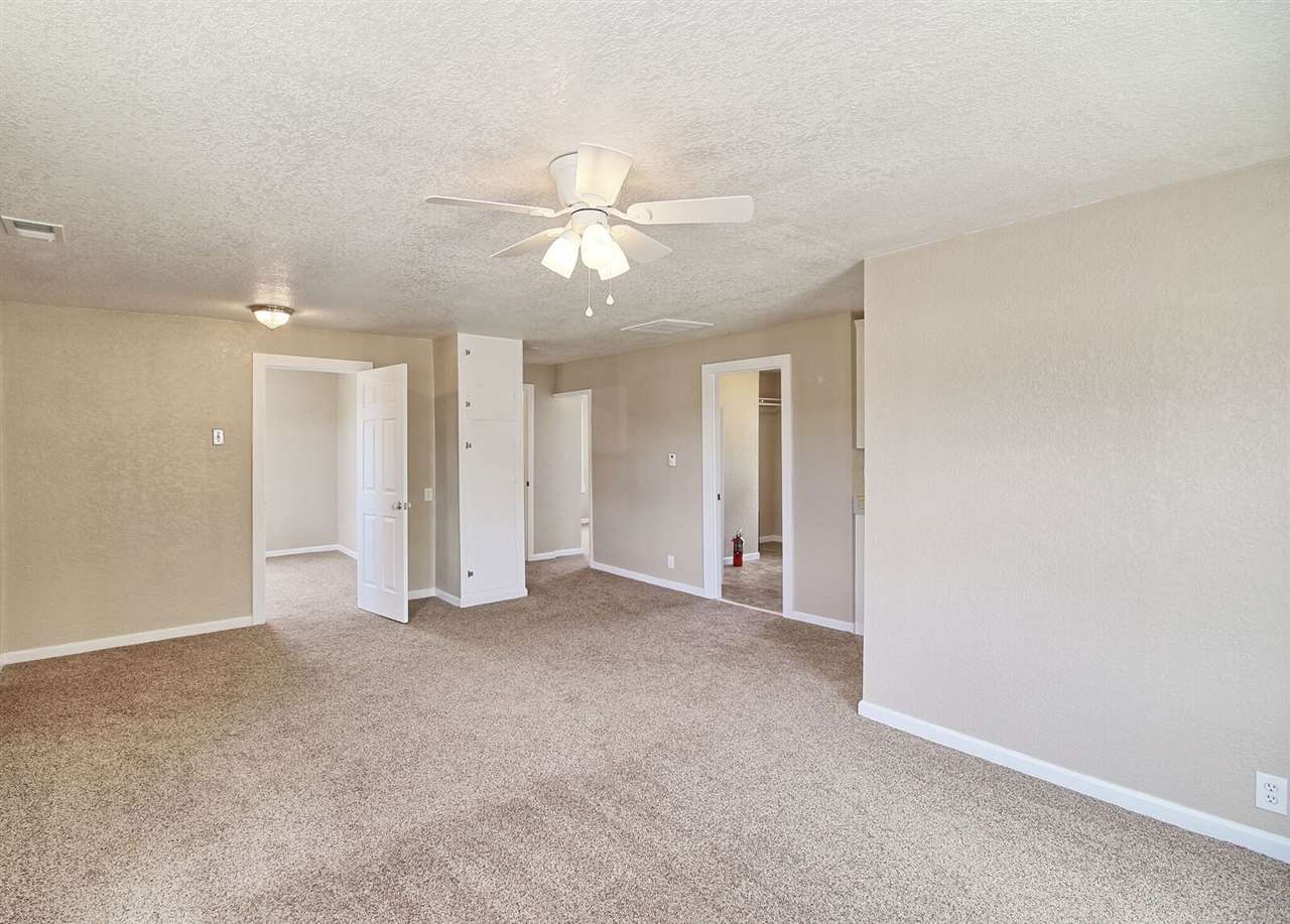 1302-17 17 1/2 Road Fruita, CO 81521 - Photo 14 of 39 an empty room with a ceiling fan and a window