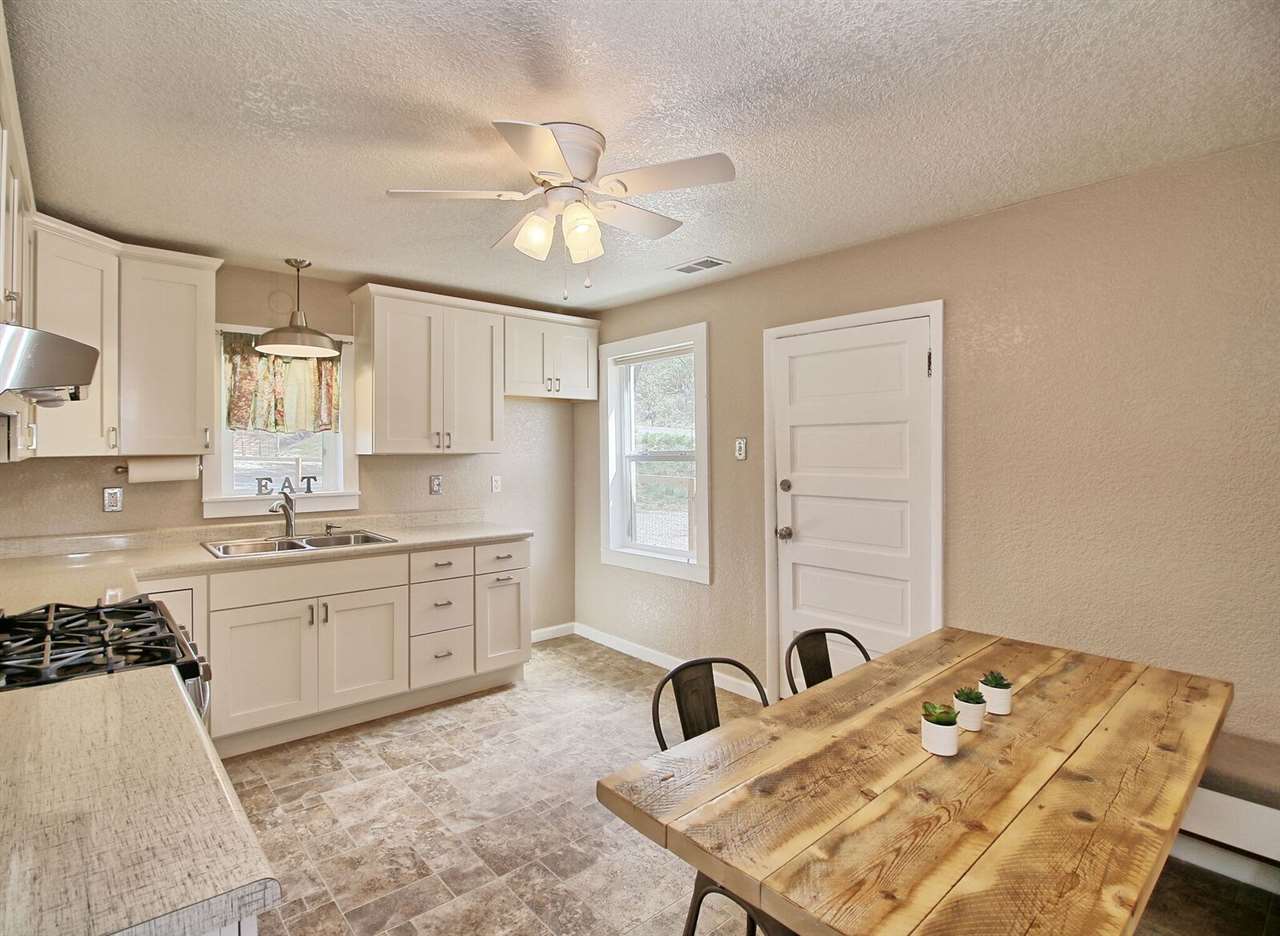 1302-17 17 1/2 Road Fruita, CO 81521 - Photo 16 of 39 a kitchen with a sink cabinets and chandelier