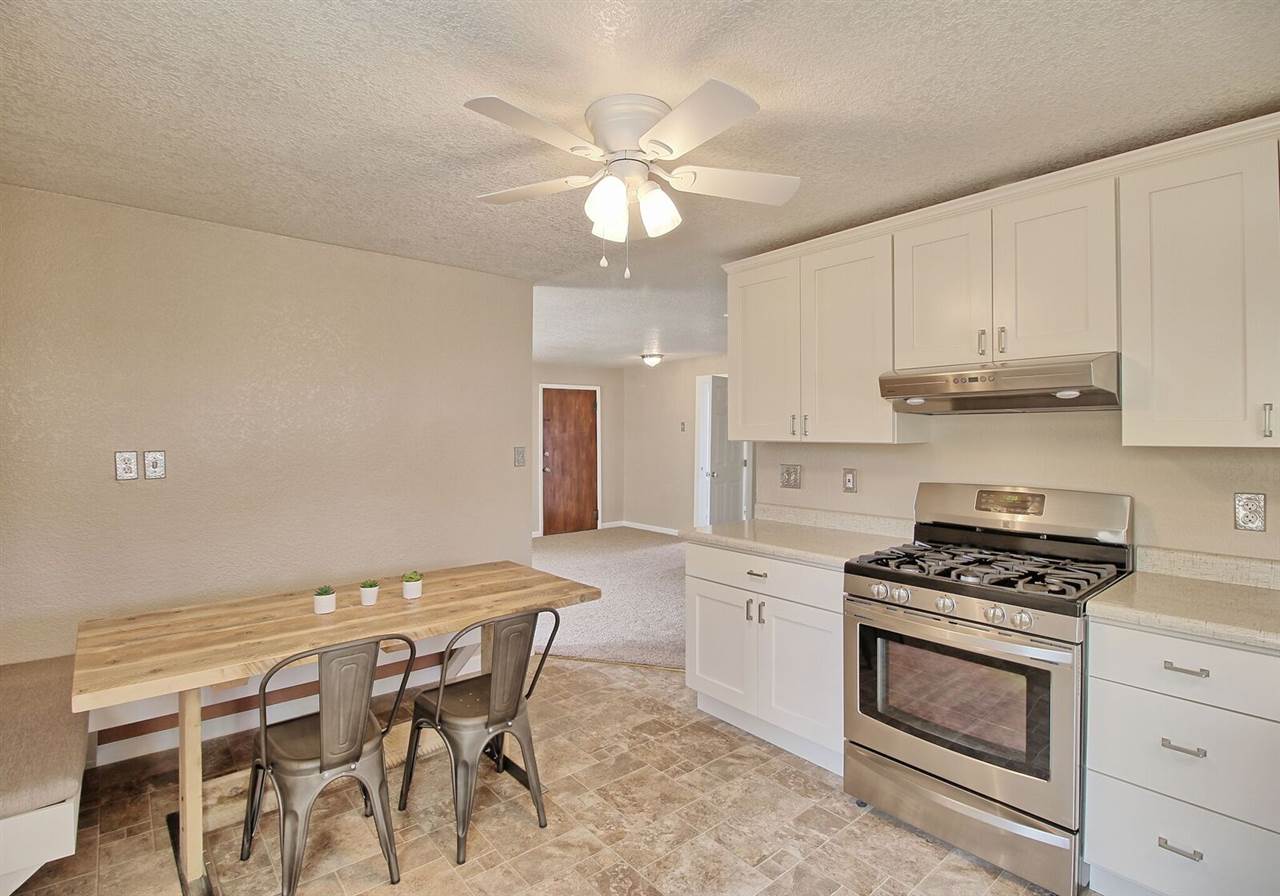 1302-17 17 1/2 Road Fruita, CO 81521 - Photo 17 of 39 a kitchen with a stove cabinets and window