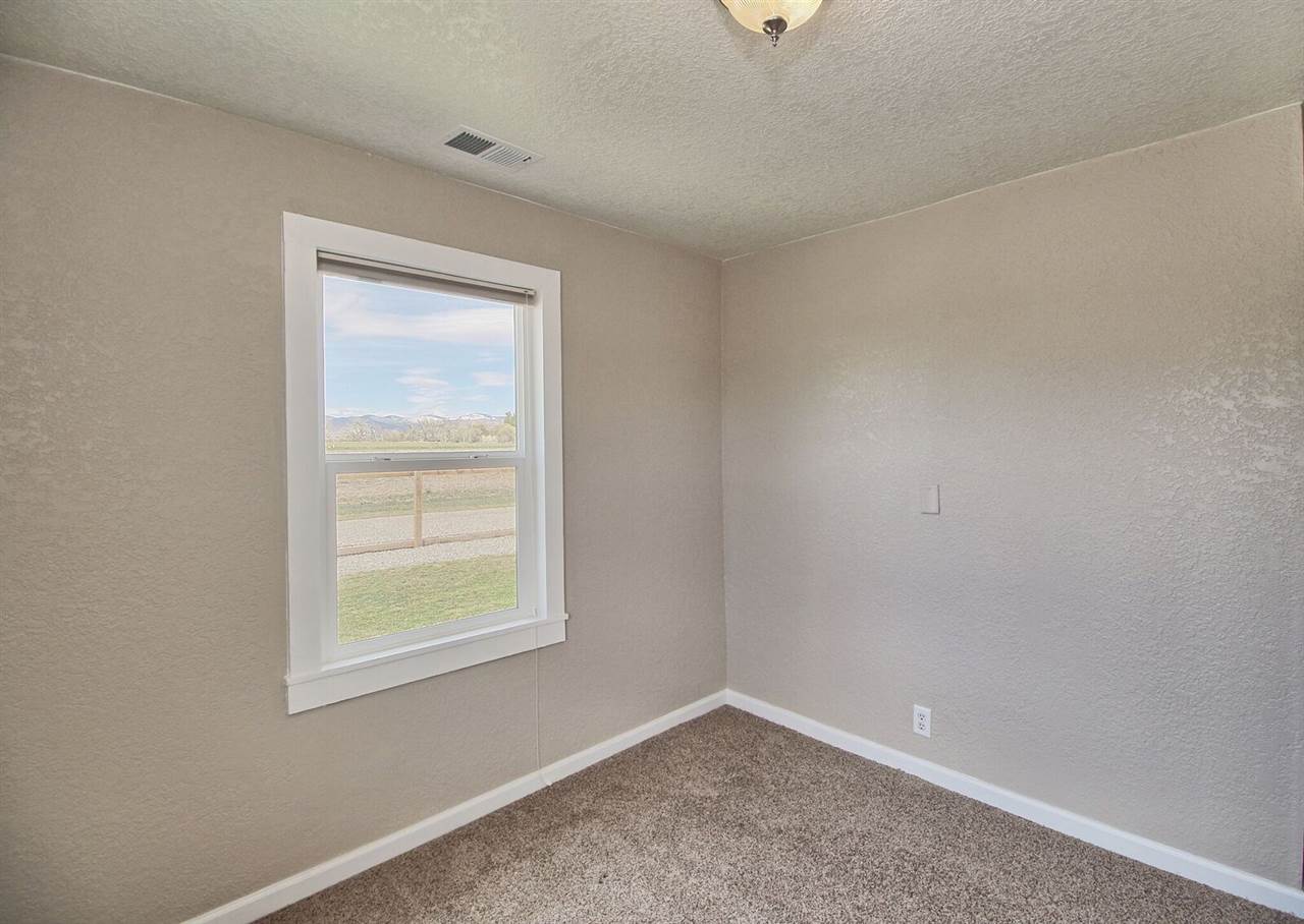 1302-17 17 1/2 Road Fruita, CO 81521 - Photo 21 of 39 an empty room with windows